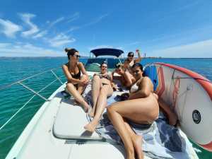 a woman sitting on a boat in a body of water