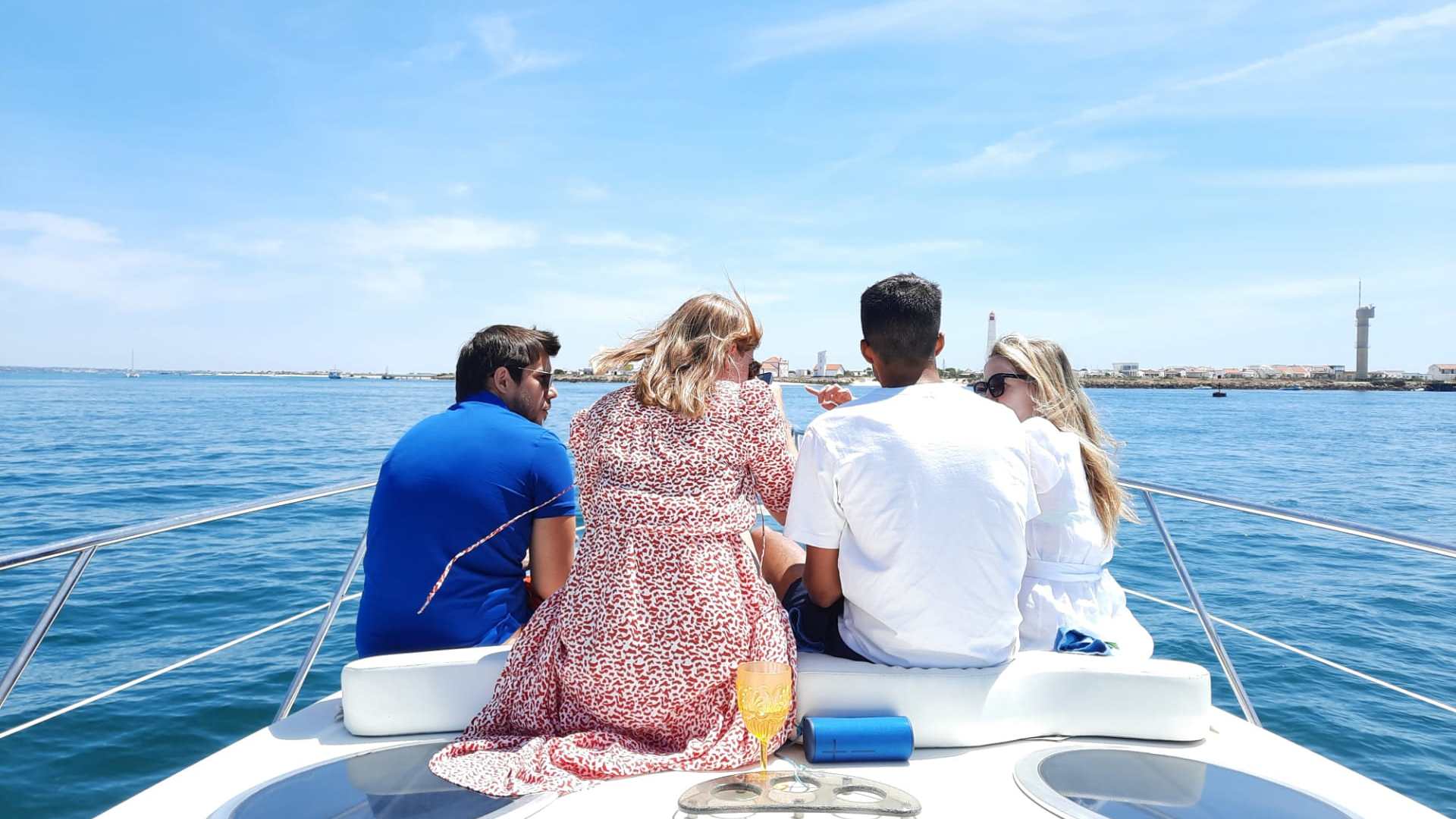 a group of people sitting in a boat on a body of water