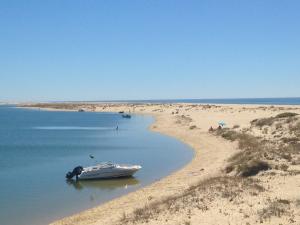 a sandy beach next to a body of water