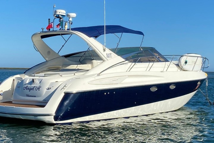 a close up of a boat next to a body of water