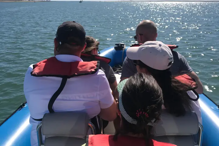 a group of people in a boat on a body of water