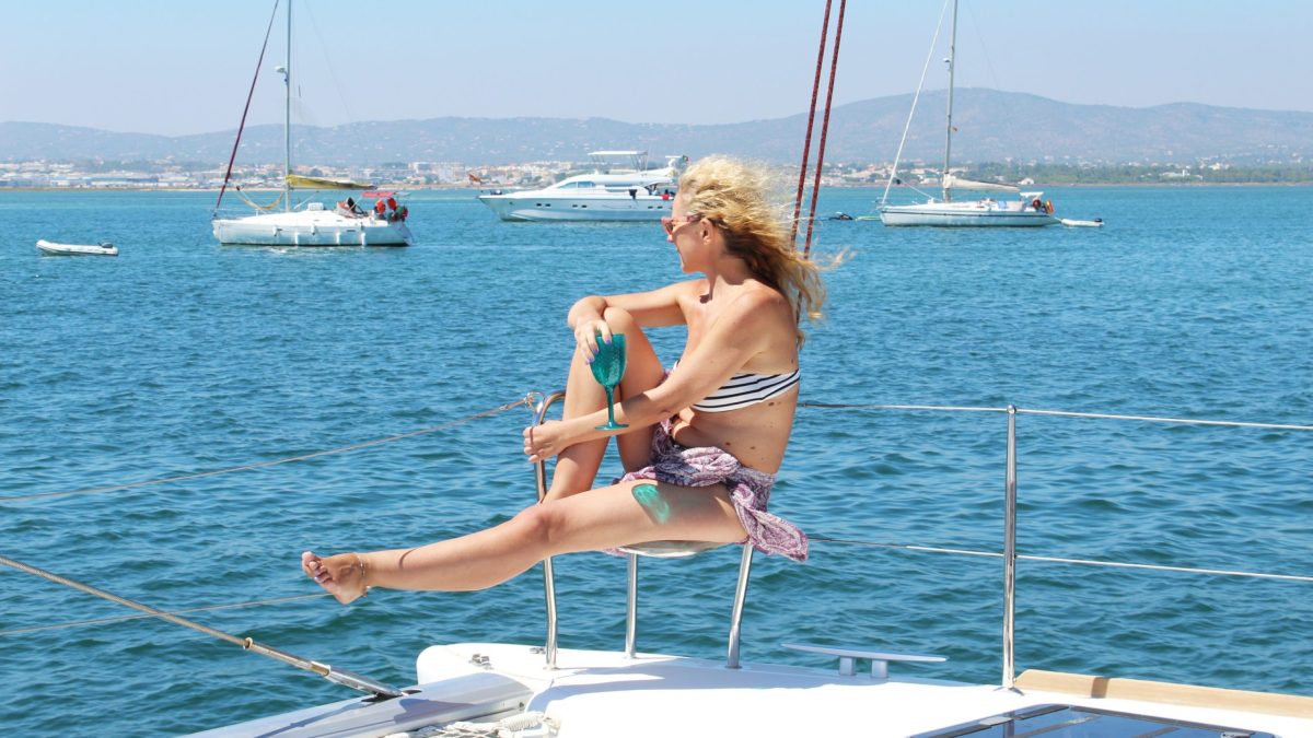 a person riding on the back of a boat in a body of water