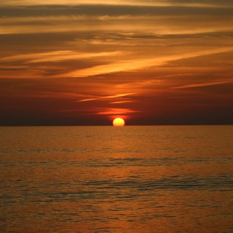 a sunset over a body of water