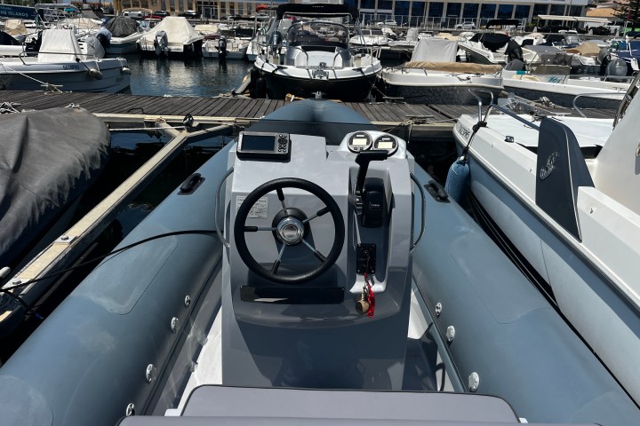 View from a docked inflatable boat overlooking a marina with several boats.