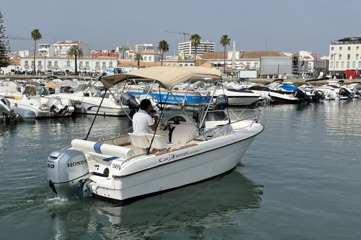 a small boat in a harbor next to a body of water